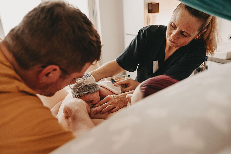 Hebamme versorgt Baby